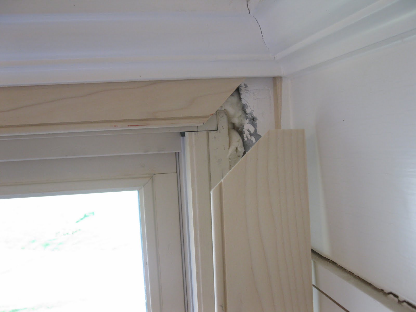 Applying Trim In Confined Spaces - Concord Carpenter A Carpenter Cut The Top Section Of A Window Frame