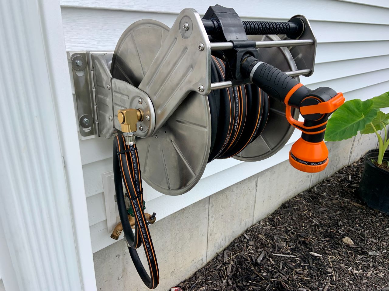 Garden hose reels with secured nozzles?